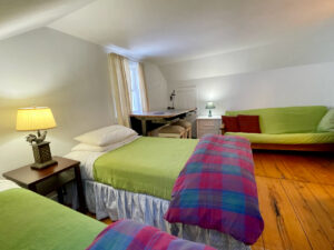 The guest bedroom. The two beds can be pushed together, there is a futon and an UpLift standing desk.